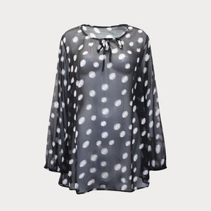 Black and white spotty top made of sheer chiffon with a tie detail at the neck and long sleeves. 