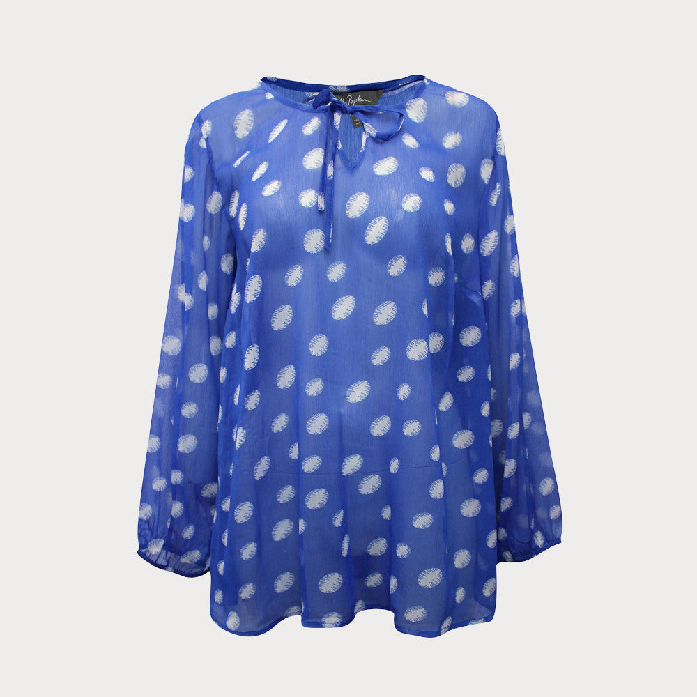 Bright blue and white spotty chiffon top with long sleeves and tie at the neck. 